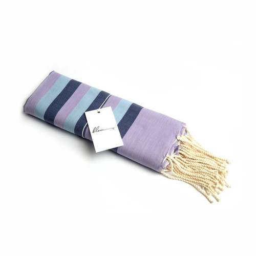 A folded blue, purple, and navy striped beach towel with tassels, featuring a tag on it. A folded blue, purple, and navy striped beach towel with tassels, featuring a tag on it.