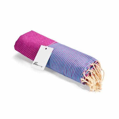 A rolled beach towel featuring purple and blue stripes with tassels at one end. It has a tag attached.
