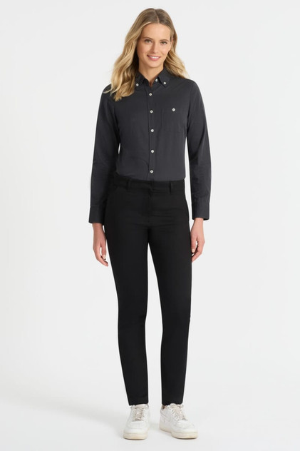 A black ladies long sleeve button-up shirt displayed on a model, paired with black pants and white sneakers. A black ladies long sleeve button-up shirt displayed on a model, paired with black pants and white sneakers.