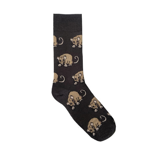 A black sock featuring a repeated design of tan animal illustrations. The sock has a grey cuff and branding. A black sock featuring a repeated design of tan animal illustrations. The sock has a grey cuff and branding.