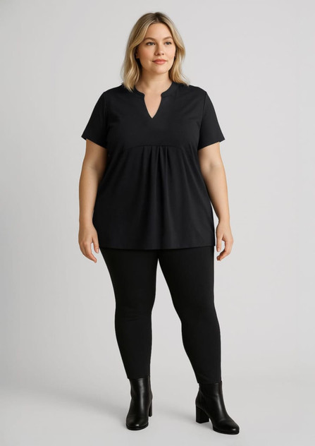 Women’s high-rise black leggings paired with a black top, featuring a V-neck and short sleeves. The model is wearing ankle boots. Women’s high-rise black leggings paired with a black top, featuring a V-neck and short sleeves. The model is wearing ankle boots.