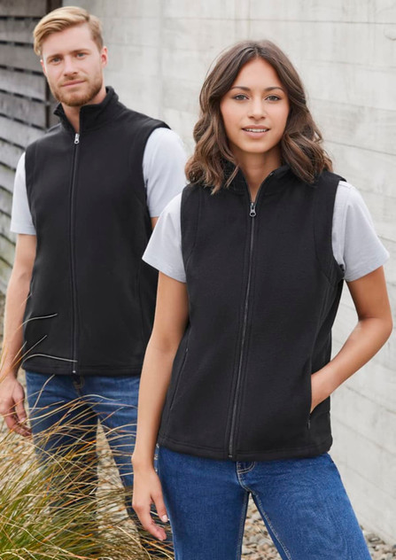 A black women's micro fleece vest with a zip, featuring side pockets, displayed on a model alongside a male counterpart. A black women's micro fleece vest with a zip, featuring side pockets, displayed on a model alongside a male counterpart.