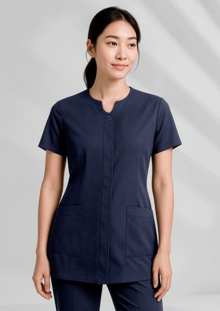 A navy women's tunic with a round neckline and two front pockets, featuring a logo on the chest.