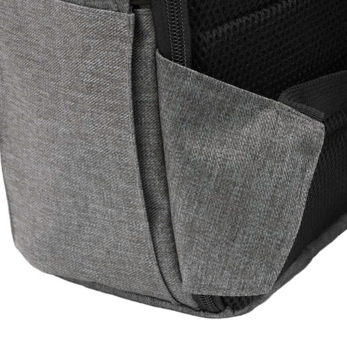 A grey computer backpack featuring a textured surface and a side pocket, with a logo on the front. A grey computer backpack featuring a textured surface and a side pocket, with a logo on the front.