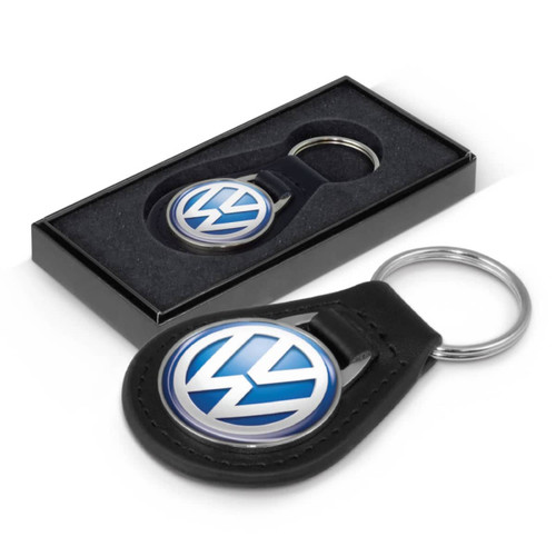 A round leather key ring featuring the Volkswagen logo, presented in a sleek black box. A round leather key ring featuring the Volkswagen logo, presented in a sleek black box.