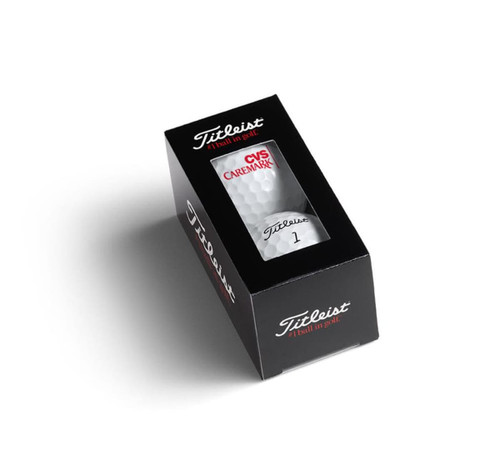 A black and white box containing two golf balls, featuring a logo and the product name.