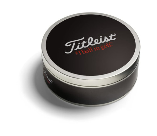 A black tin containing three Titleist golf balls, featuring a branded logo on the lid. A black tin containing three Titleist golf balls, featuring a branded logo on the lid.