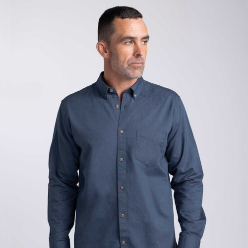 A men’s button-up shirt in navy blue with a button-down collar and a chest pocket. It features a logo.