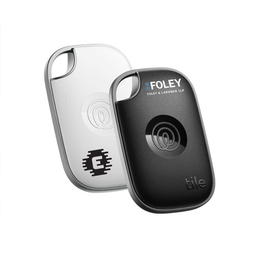 A black and a white Tile Pro tracker, featuring a logo on the black one, in a sleek design.