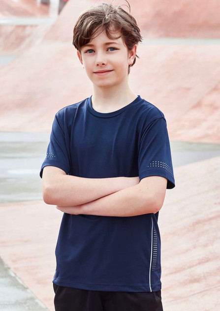 A navy blue short sleeve tee for kids with a logo and dotted design on the sleeves, modeled by a smiling boy. A navy blue short sleeve tee for kids with a logo and dotted design on the sleeves, modeled by a smiling boy.