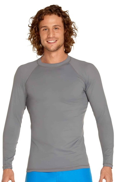 A man wearing a grey long sleeve rashie with a fitted design. The garment features a round neckline and long sleeves. A man wearing a grey long sleeve rashie with a fitted design. The garment features a round neckline and long sleeves.