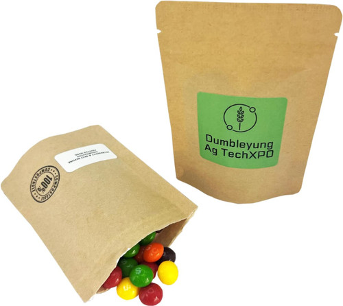 A compostable bag filled with colourful Skittles lollies, displayed alongside another similar bag. A compostable bag filled with colourful Skittles lollies, displayed alongside another similar bag.