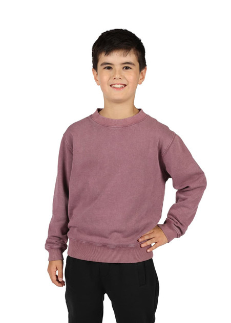 A unisex stone wash sweatshirt in a muted mauve colour, worn by a smiling child with dark hair, standing in a casual pose.