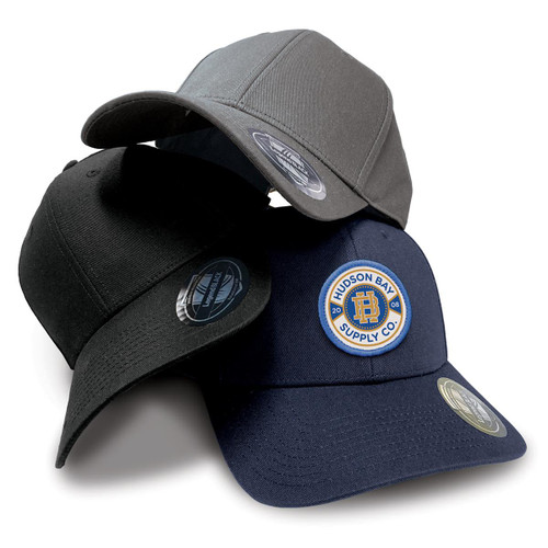 Three caps in grey, black, and navy, featuring a logo on the front, stacked together on a white background.
