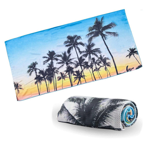 A sand-free beach towel featuring a vibrant sunset with palm trees, presented rolled up and flat.
