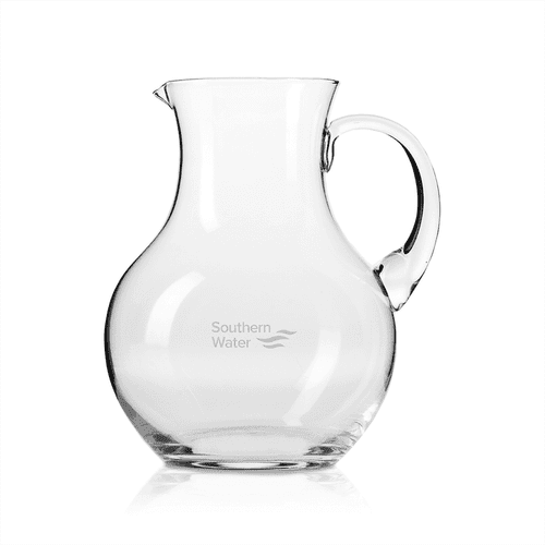 A glass jug with a curved shape and a handle, featuring a small logo. Transparent and elegantly designed.