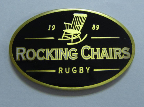 A black and gold hard enamel lapel pin featuring an illustration of a rocking chair with "Rocking Chairs Rugby" inscribed.