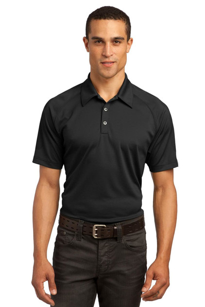 A black OGIO Optic Polo shirt on a male model, featuring a collar and branding. Suitable for casual or professional wear.