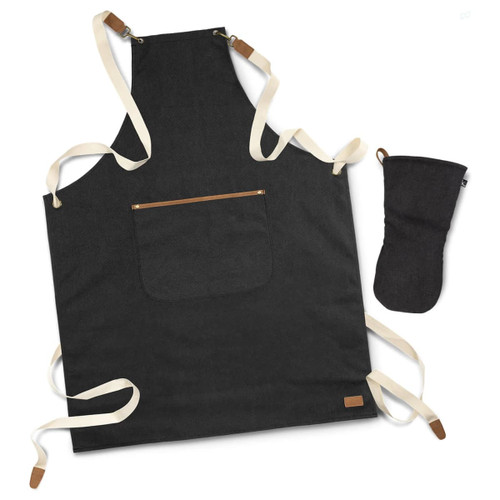 A dark denim apron with cream straps and a pocket, accompanied by a matching dark oven mitt.
