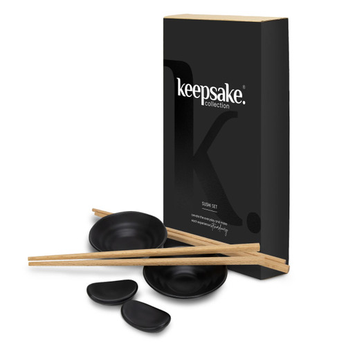 A sushi set featuring black bowls, wooden chopsticks, and a branded packaging box.