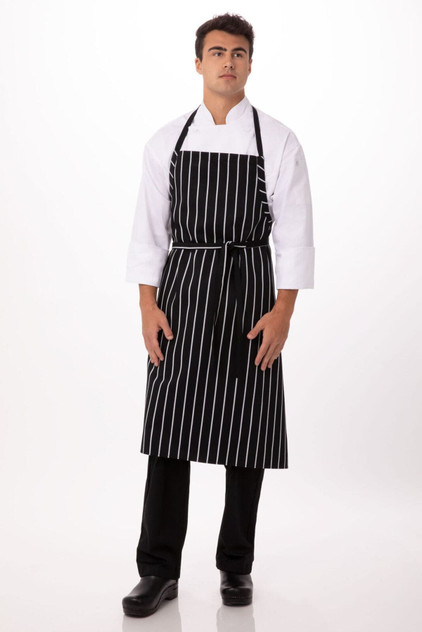 A black and white striped chef apron worn by a model, featuring a logo on the front.
