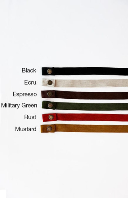 A selection of Lockharte Waist Apron Straps in black, ecru, espresso, military green, rust, and mustard, with buttons.