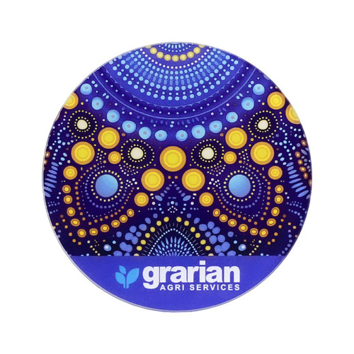 A round glass coaster featuring a vibrant purple and yellow dot pattern, with a logo at the bottom.