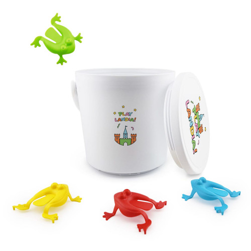 A white container with a lid and colourful plastic frogs in green, yellow, red, and blue. The container features a logo.
