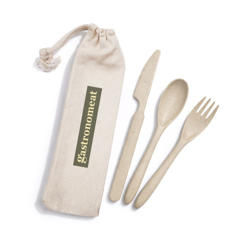 A calico pouch containing a beige cutlery set with a knife, fork, and spoon. The pouch has a logo.