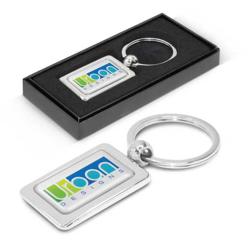 A rectangular metal key ring featuring a customizable design, presented in a sleek black box. A rectangular metal key ring featuring a customizable design, presented in a sleek black box.