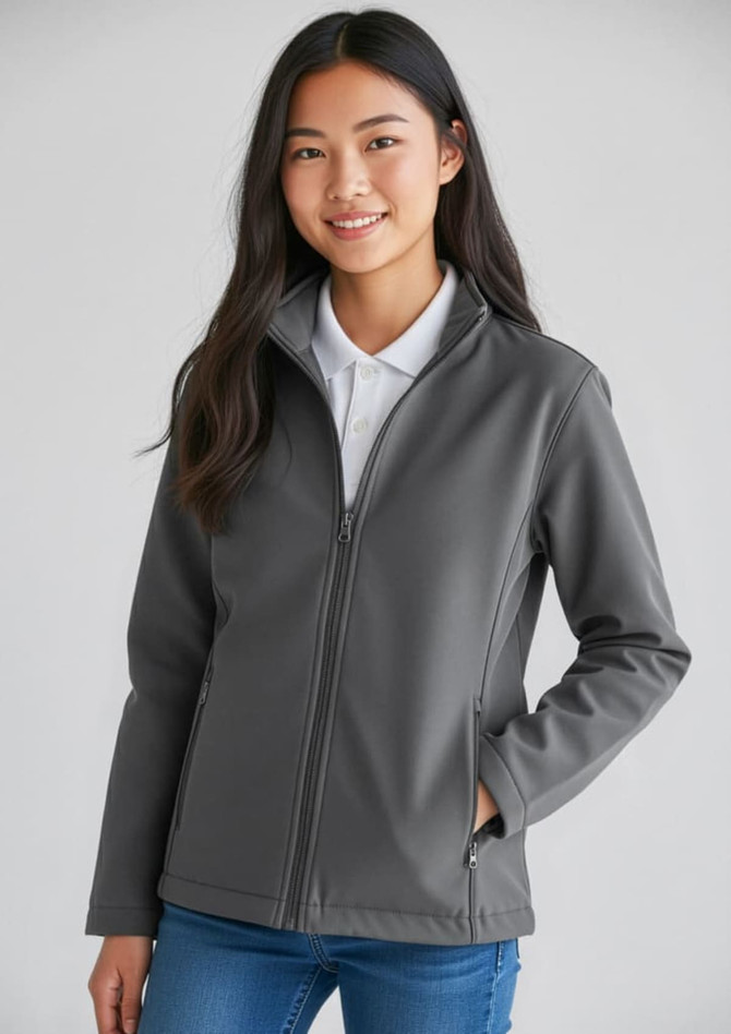 A grey Kids Apex Jacket featuring a front zip and a stand-up collar, modelled by a smiling young person.