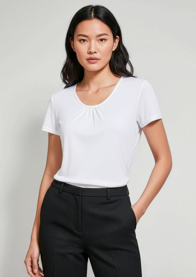 A women's chic top in white, featuring a scoop neckline and short sleeves, worn with tailored black trousers.