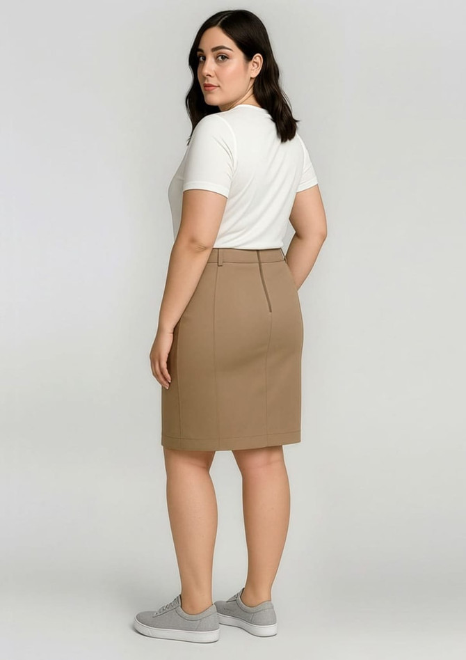A mid-waist stretch chino skirt in a tan colour, paired with a white short-sleeve top. Features a rear view with a logo.