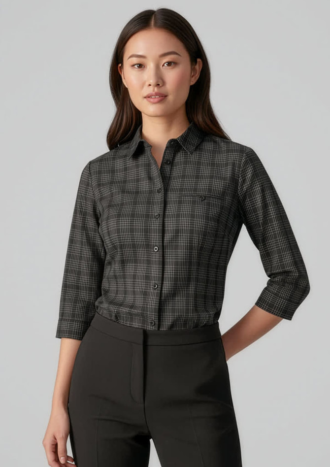 A women's black and white check patterned 3/4 sleeve button-up shirt with a chest pocket. Features a logo.