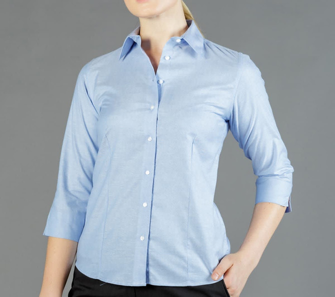A light blue button-up shirt with a fitted design and three-quarter length sleeves. It features a collar and branding.