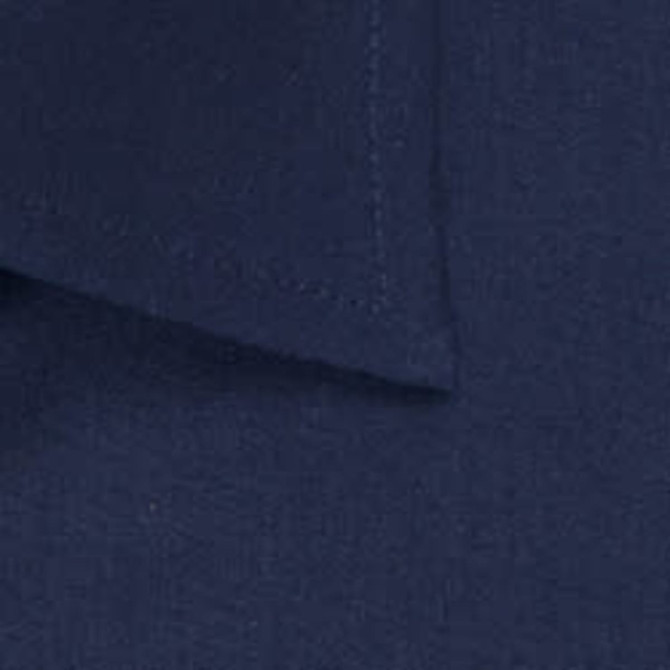A close-up view of a navy blue button-up shirt with a folded collar and clean stitching. It has a logo visible.
