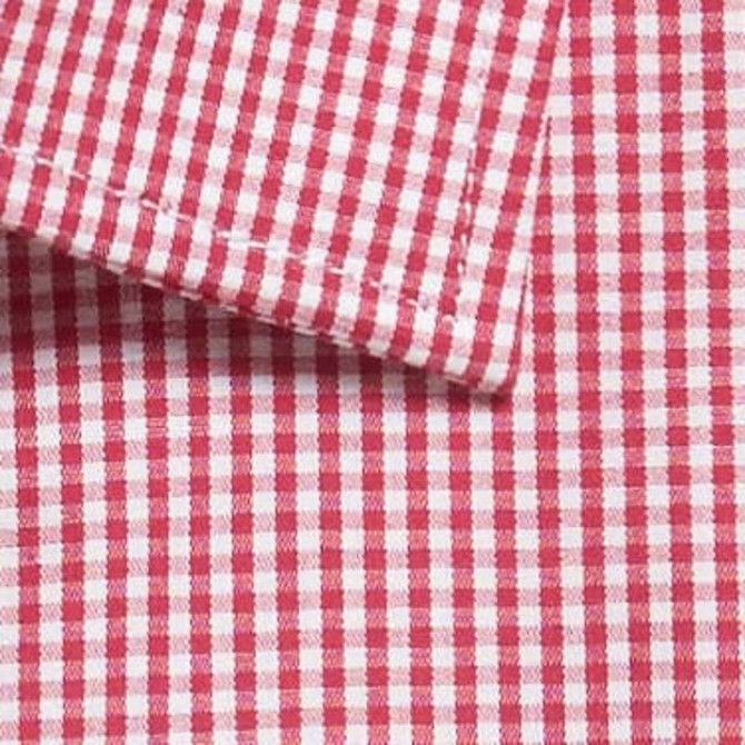 A close-up of a red and white gingham patterned fabric with a folded collar section and visible stitching.