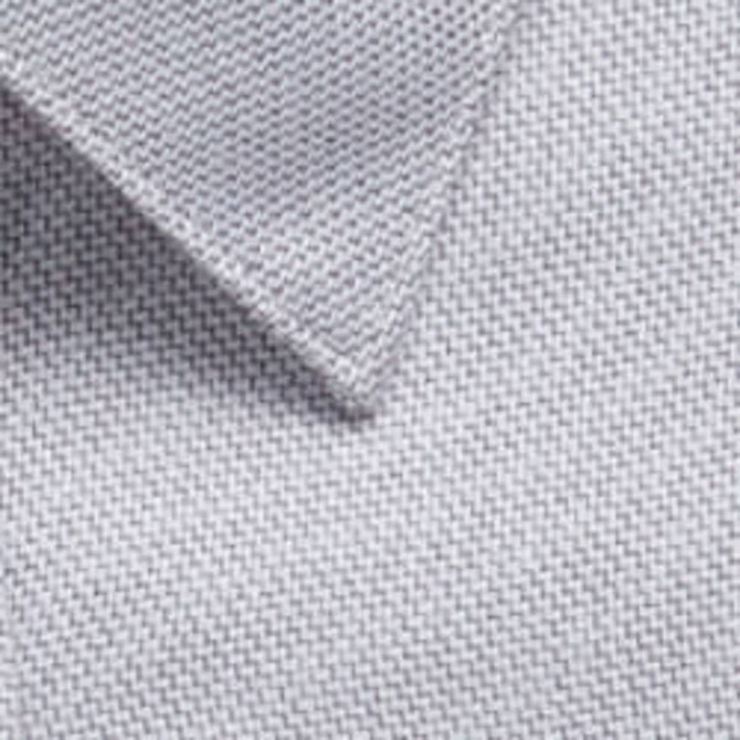 A close-up of a light grey woven fabric with a textured surface, featuring a collar edge and a logo.