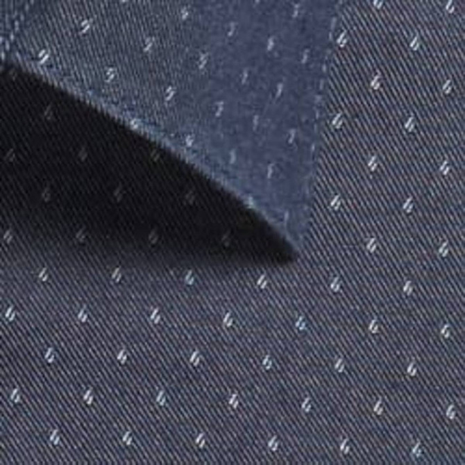 A close-up of a dark chambray fabric featuring a subtle pattern of small, light-coloured dots.