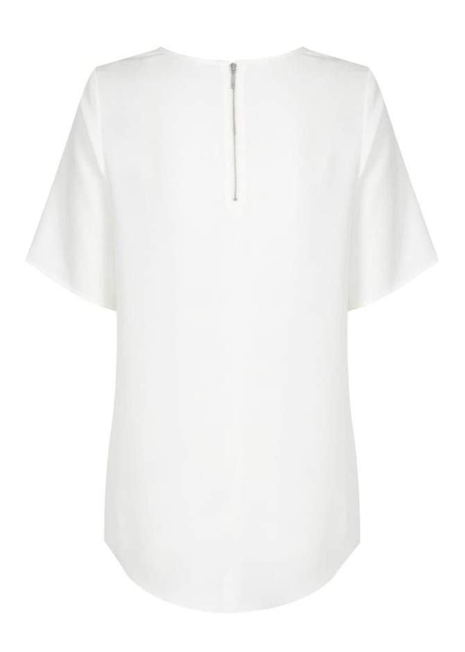 A white short sleeve shirt with a zip at the back and a curved hemline. It has a logo on the label.