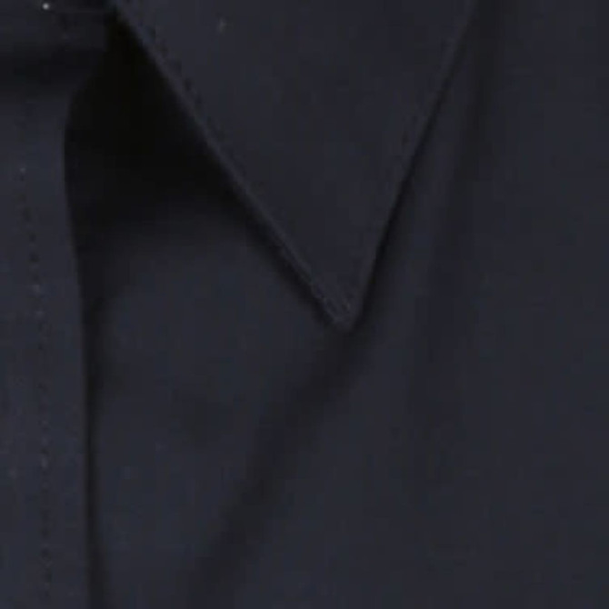 A dark navy button-up shirt with a pointed collar, featuring a logo.
