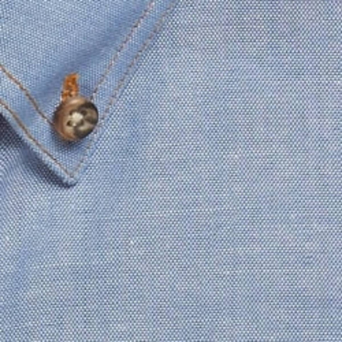 A blue work shirt featuring a buttoned collar and a textured fabric, with a logo on the side.