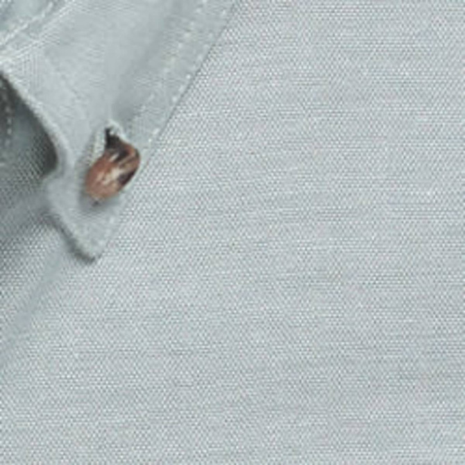 A close-up of a light grey work shirt fabric featuring a button detail.