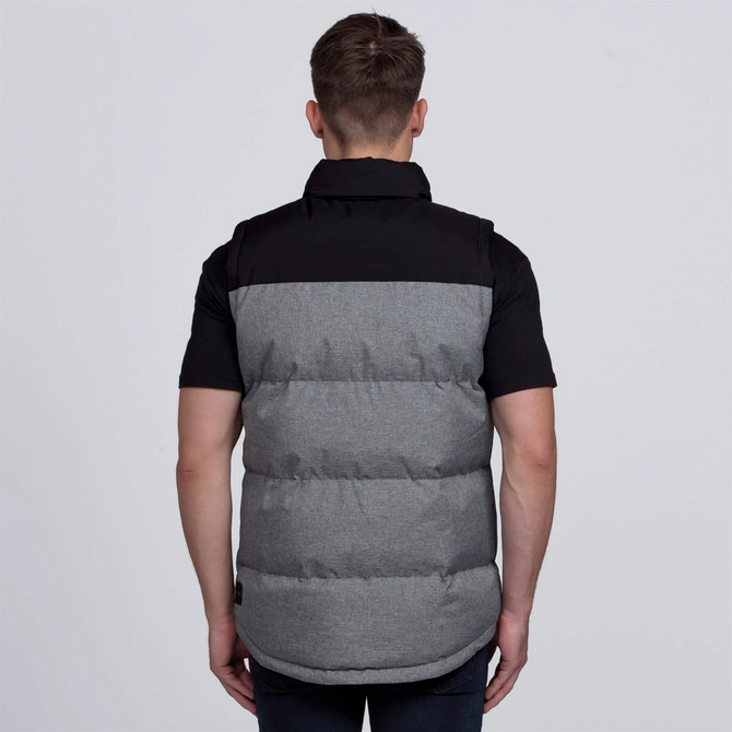 A puffa vest in grey and black with a branding logo, featuring a padded design and a collar.