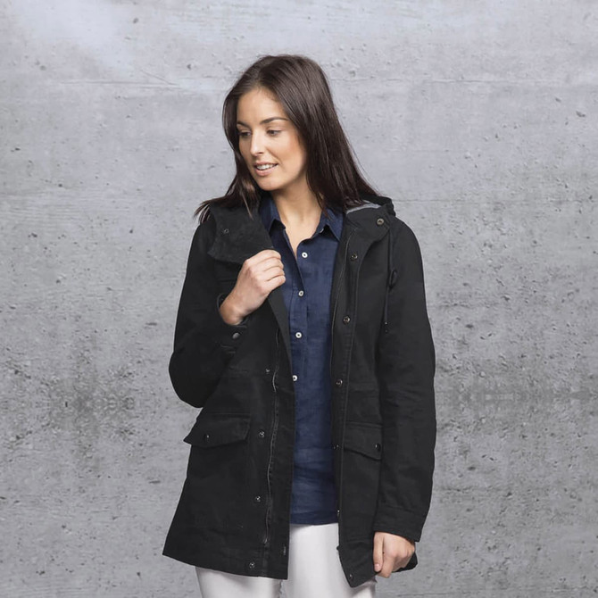 A woman models a black twill jacket featuring a hood, with pockets and a casual style. A woman models a black twill jacket featuring a hood, with pockets and a casual style.