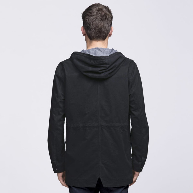 A black twill jacket featuring a hood and a stylish cut, shown from the back. It has a logo on the back. A black twill jacket featuring a hood and a stylish cut, shown from the back. It has a logo on the back.