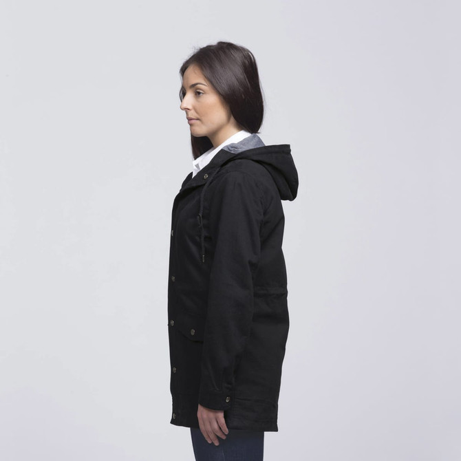 A black twill jacket with a hood, featuring a side view of a woman wearing it. The jacket has a logo. A black twill jacket with a hood, featuring a side view of a woman wearing it. The jacket has a logo.