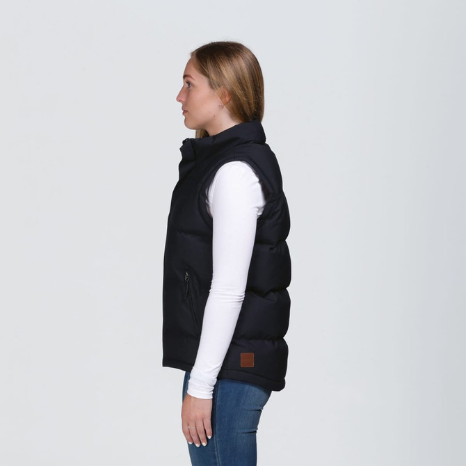 A black puffa vest with a high collar and side pockets, featuring a logo, displayed on a model.