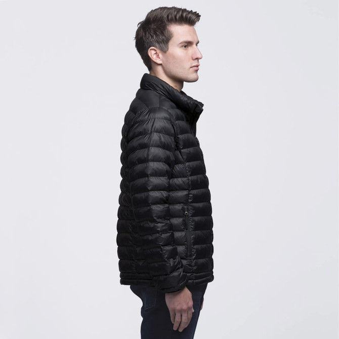 A black puffer jacket with a zip closure and a high collar, featuring a logo. Model displayed in profile. A black puffer jacket with a zip closure and a high collar, featuring a logo. Model displayed in profile.