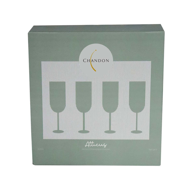 A green box containing four ribbed champagne glasses, featuring a circular logo on the front. A green box containing four ribbed champagne glasses, featuring a circular logo on the front.
